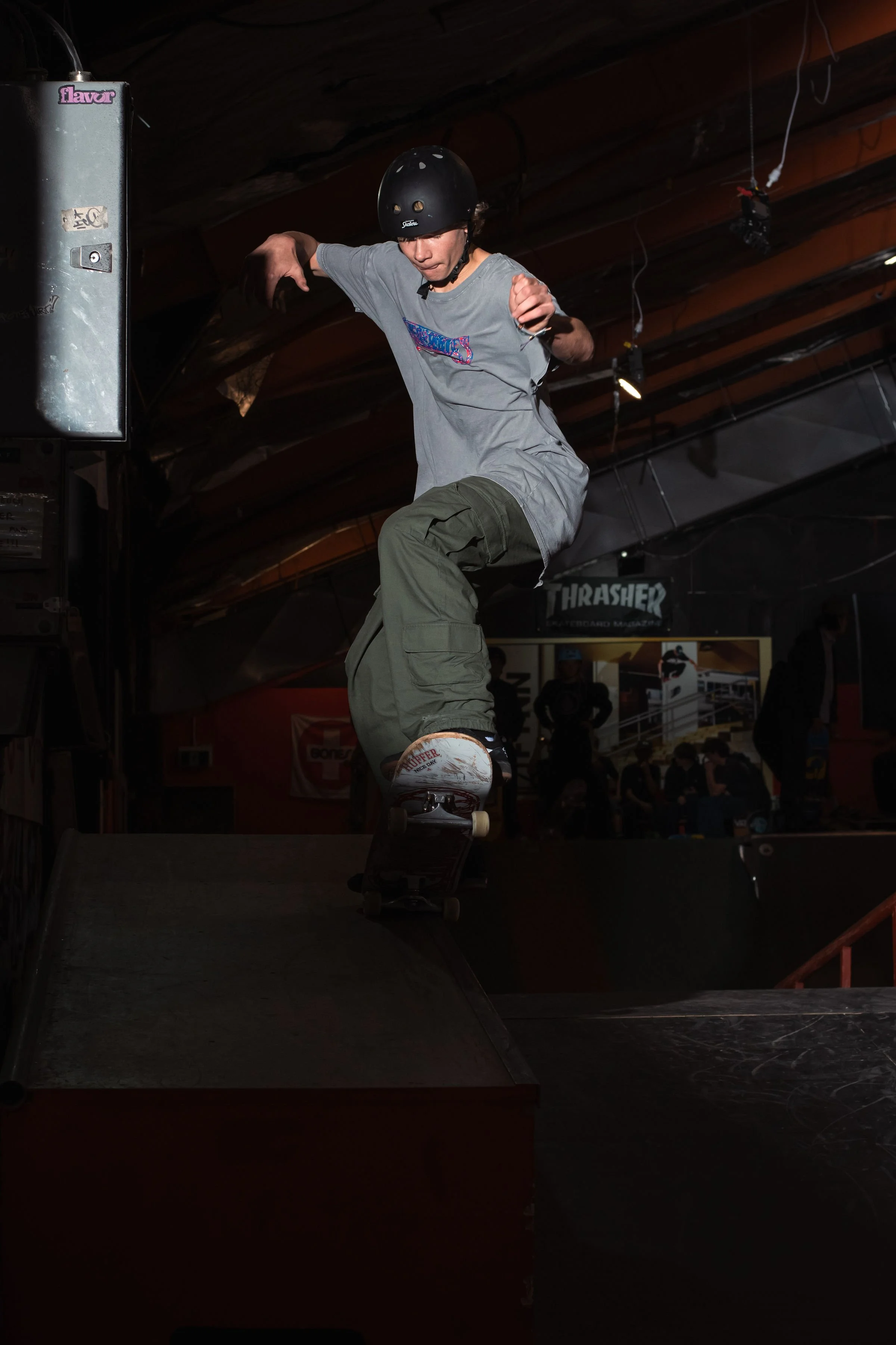 Skateboarder performing a trick on a ramp indoors
